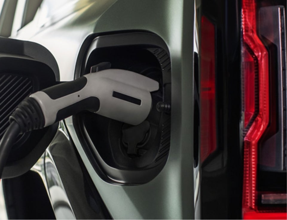 Close up of charging port with charger plugged in on a GMC Hummer EV SUV - Barker Buick GMC in HOUMA LA